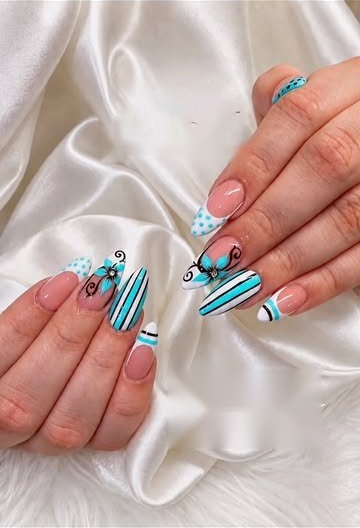 Short nails with blue and white hand-painted art on satin