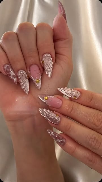 Long stiletto nails in nude with gold and white hand-drawn detail